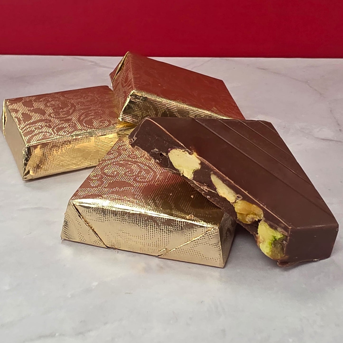 Milk chocolate piece with whole roasted pistachio kernel, handmade by TAWDI