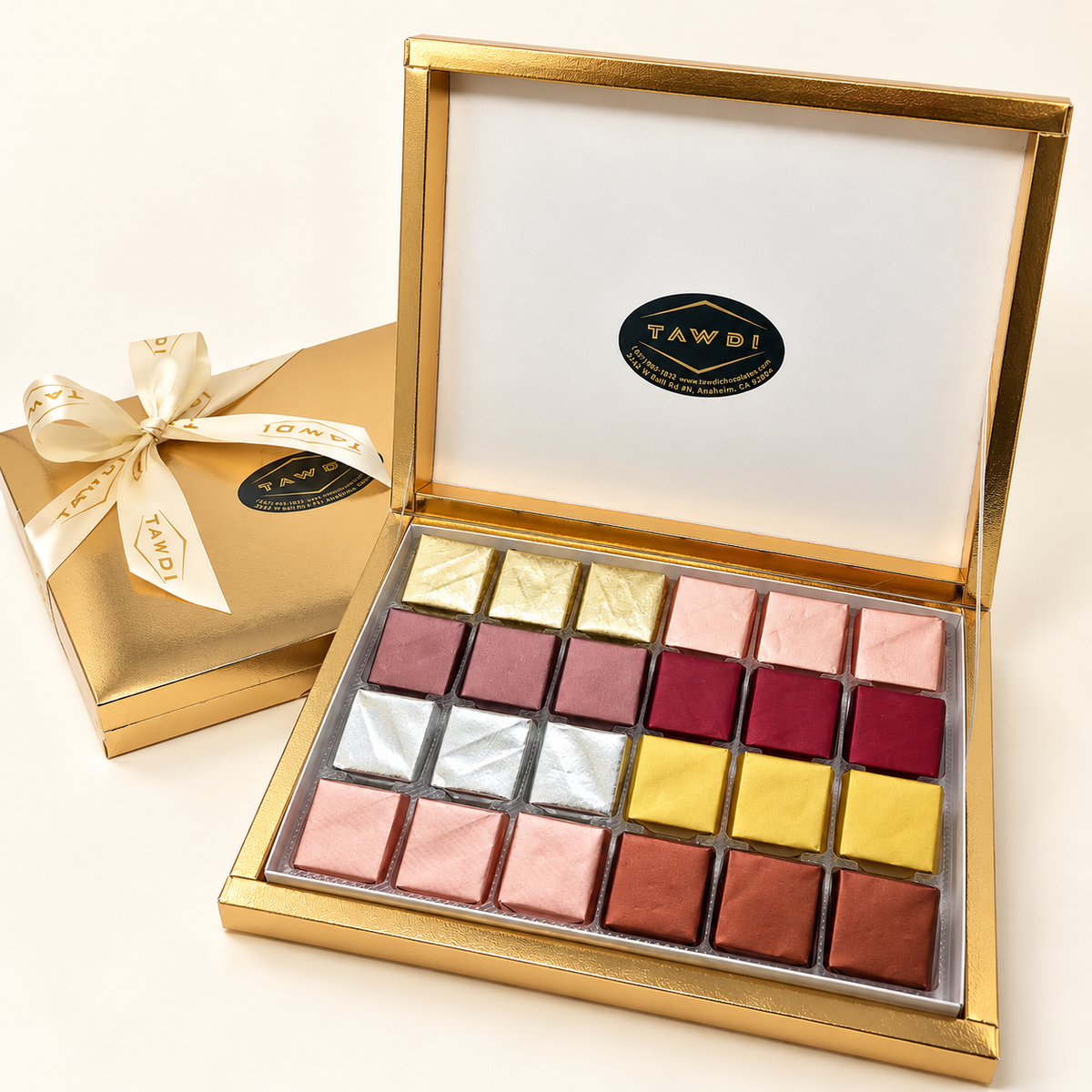 Gold TAWDI Signature Box open, showing 24 assorted handcrafted chocolates
