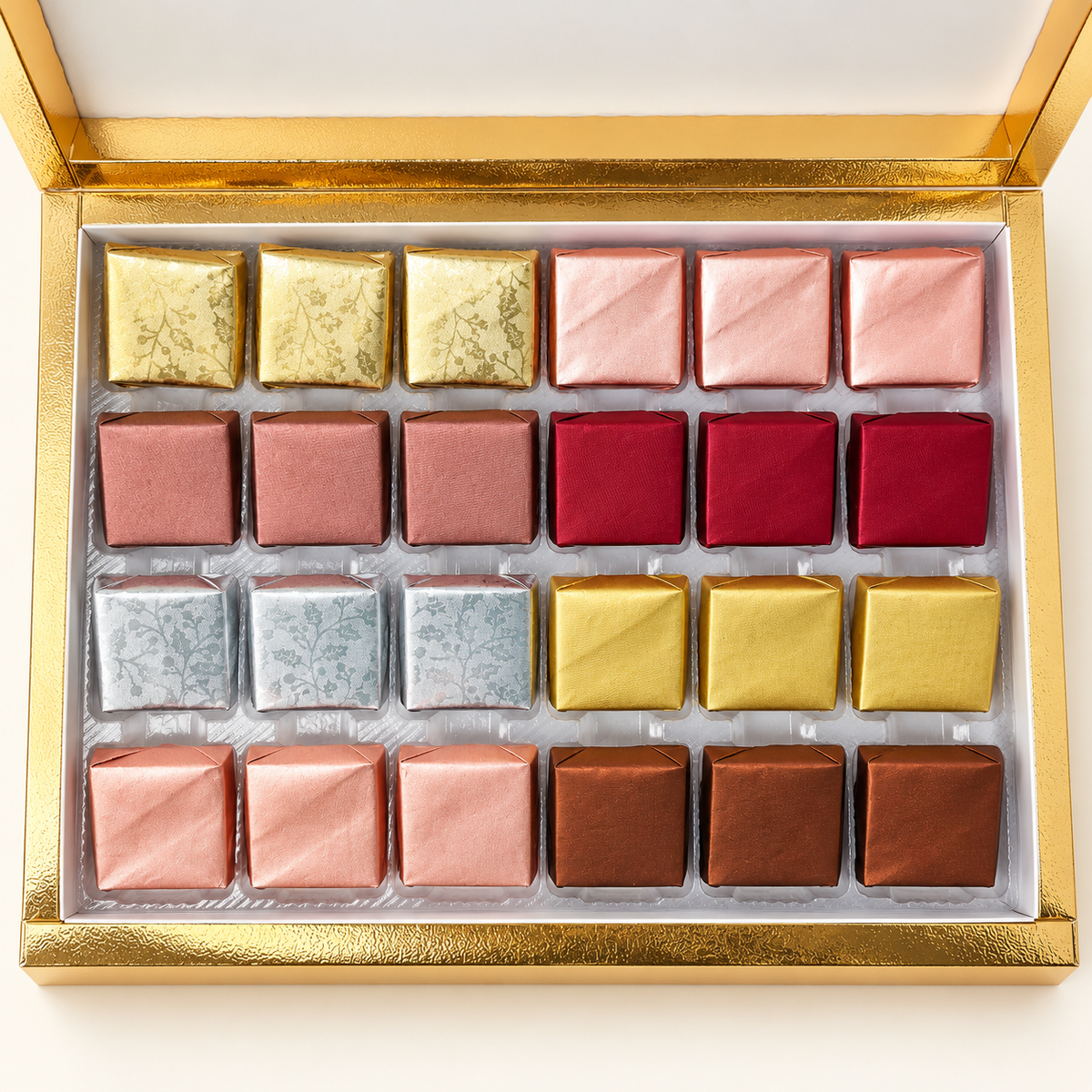 Top view of 24 assorted handcrafted chocolates in the gold TAWDI Signature Box