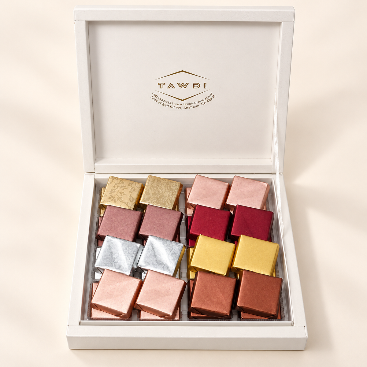 White TAWDI Signature Box, 32-piece size with two layers, lid open, angled view (top layer shown)