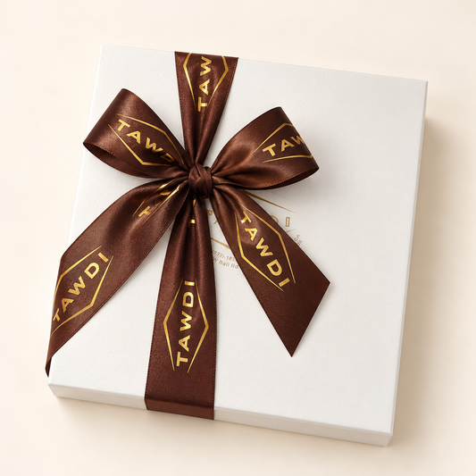 TAWDI Signature Box in white with a brown TAWDI ribbon, closed