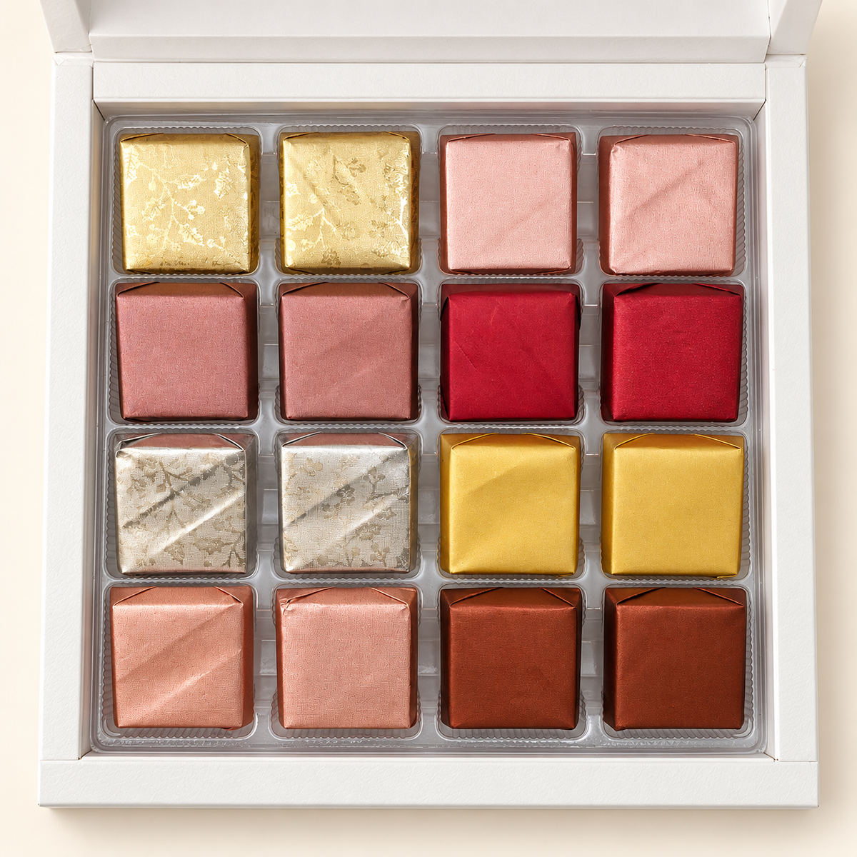 Top view of 16 assorted handcrafted chocolates in the white TAWDI Signature Box